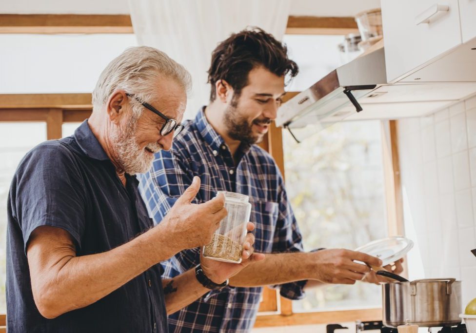 Elder cooking in the kitchen with his son, Happy family man moment good mentor old man care from son. Elder cooking in the kitchen with his som, Happy family man moment good mentor old man care from som.